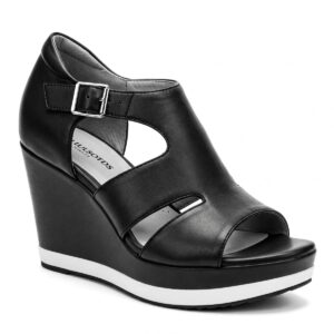 Comfortable black and white wedge sandals offering added height.