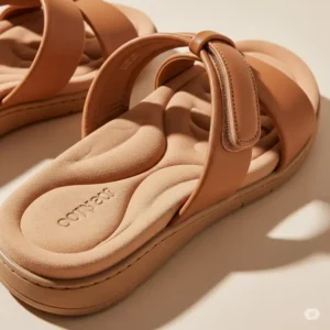 Detailed view of a comfortable flat sandal featuring a cushioned insole and soft straps, emphasizing comfort