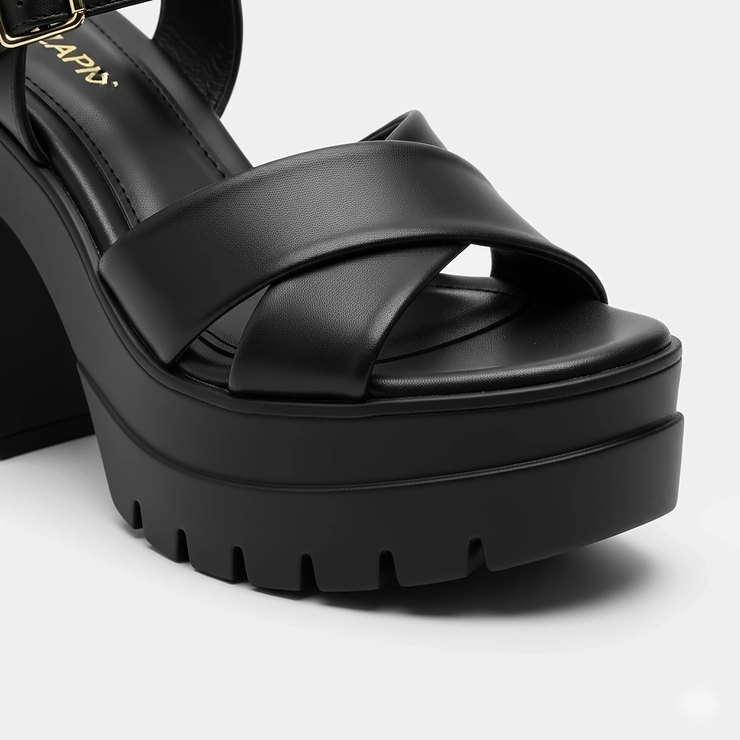 Close-up of the heel and platform on black high heel platform sandals, demonstrating stability and height.