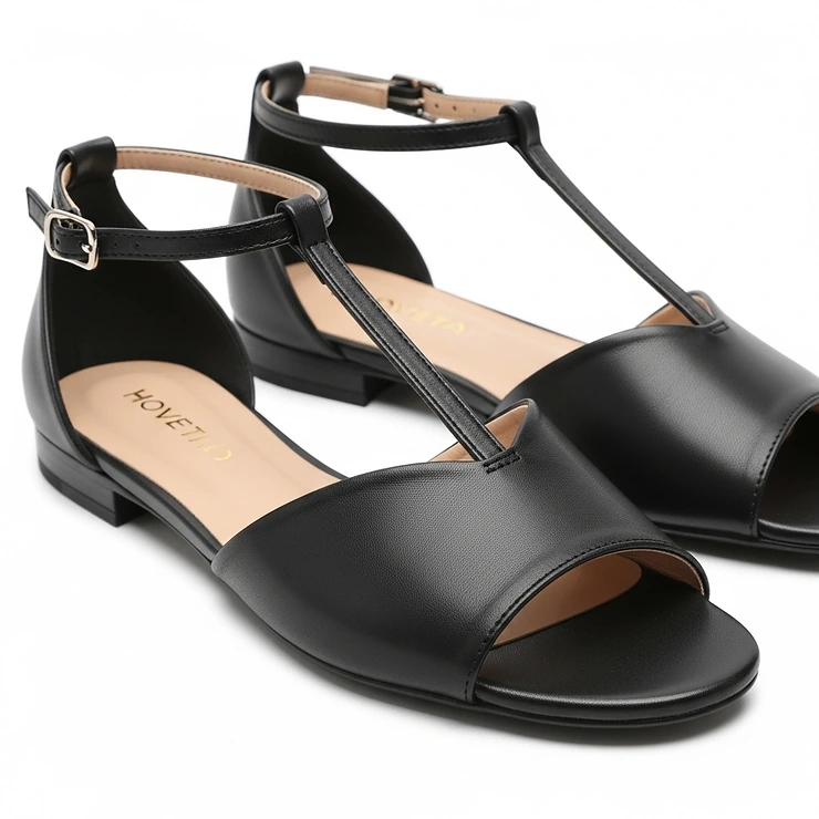 Elegant black open-toe flat dress sandals, a versatile choice for summer events or semi-formal gatherings.